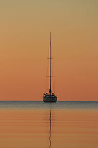 photo of gray and black boat during sunset thumbnail