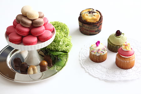 cupcakes on plate and stand above white surface thumbnail