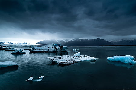 ice chunks on body of water near mountain thumbnail