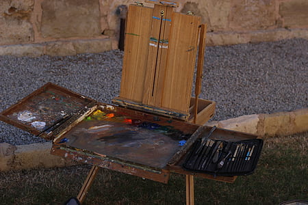 brown wooden painting easel board on ground at daytime thumbnail
