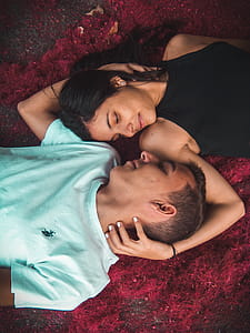 Couple Lying on Ground While Holding Their Hands thumbnail