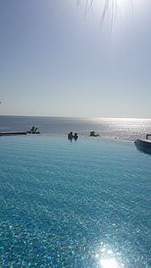 two people on pool overlooking sea during daytime thumbnail