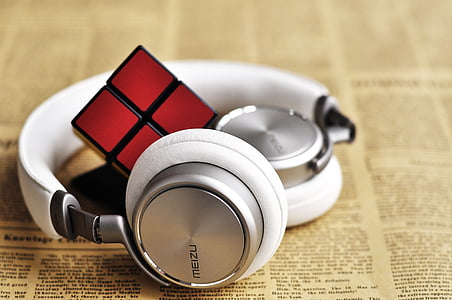silver Meizu headphones and 2 by 2 Rubik's cube thumbnail