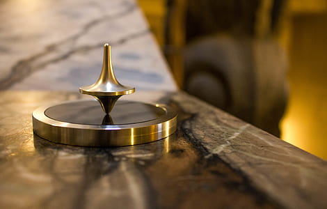 selective focus photography of gray stainless steel spin top thumbnail