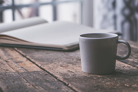 white ceramic mug on table thumbnail