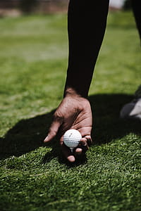 Person Holding White Golf Ball thumbnail