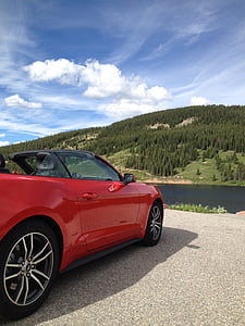 red Chevrolet Camaro convertible parked near body of water thumbnail