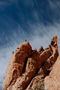 two person climbing on large rock during daytime thumbnail