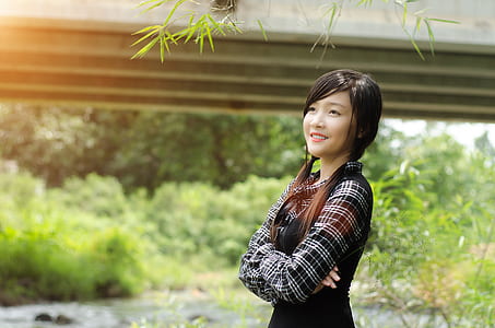 woman standing near gray concrete beam thumbnail
