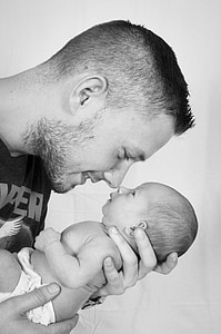 smiliing man holding baby thumbnail
