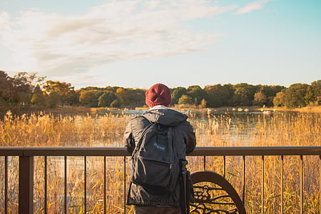 man lean in rail beside water thumbnail