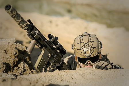 man holding gray tactical rifle thumbnail