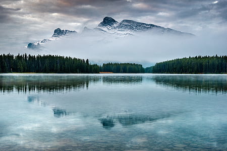 snow covered mountain across lake thumbnail