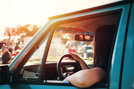 woman driving car during daytime thumbnail