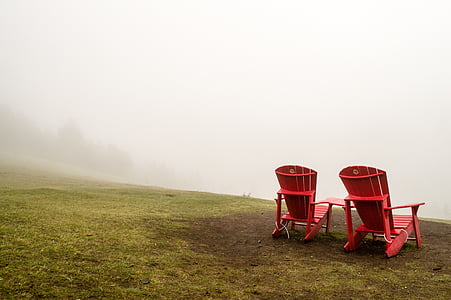 two red Adirondack chairs on field thumbnail