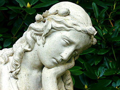 female statue near leafed plants thumbnail