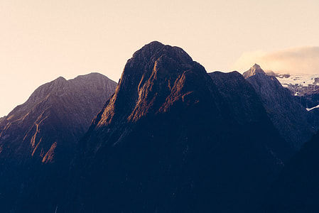 photography of mountain peak under white clouds thumbnail