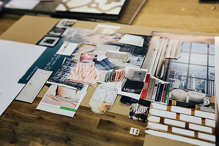 Designers working with material samples and paper cutouts thumbnail