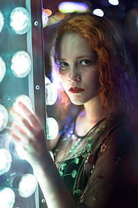 Woman in Green Dress Holding Gray Steel Frame thumbnail