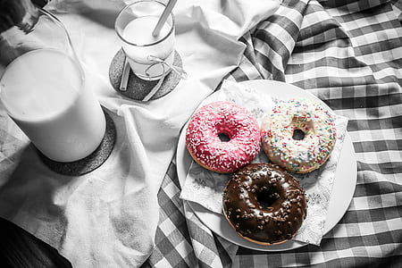 three doughnuts on round white plate thumbnail
