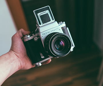 person holding black and gray Pentagon camera thumbnail