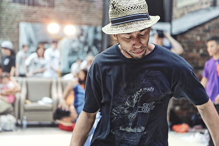 selective focus photography of man wearing bucket hat looking below his shirt thumbnail