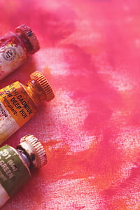 three assorted-color plastic bottles thumbnail