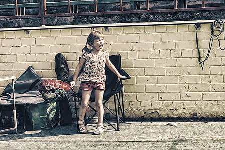 photo of girl standing beside camping chair thumbnail