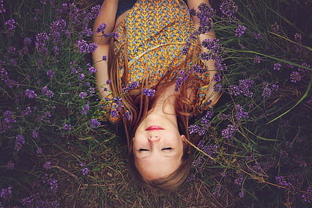 woman laying on garden beside lavenders thumbnail