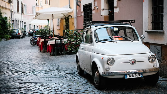 white FIAT 126 parked near brown house thumbnail
