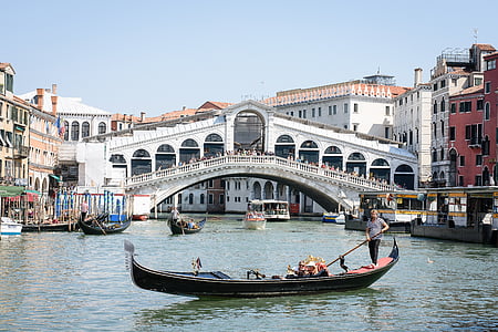 black boat near white bridge during daytime thumbnail