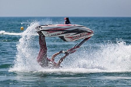 man riding white and red personal water craft thumbnail