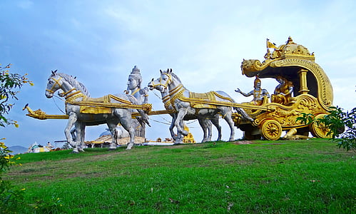 statue of people on wagon pulled by horses thumbnail