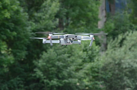 white drone flying in forest thumbnail