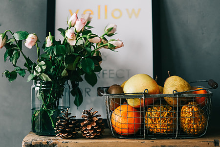 Assorted accessories with flowers and fruit on a shelf thumbnail