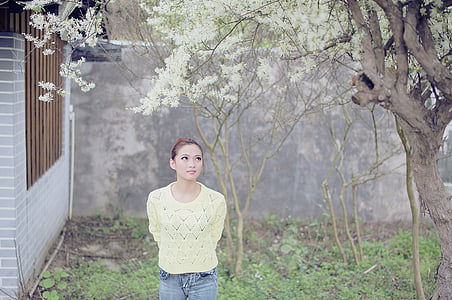 brown haired woman in white top and blue denim bottoms thumbnail