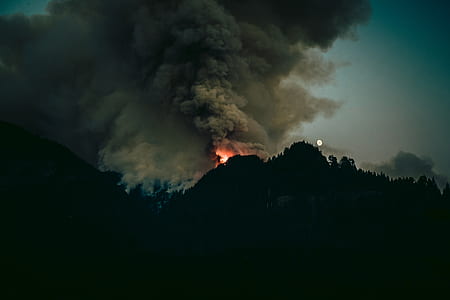 silhouette of mountain with fire on top thumbnail