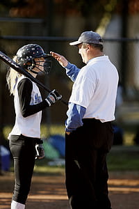 man and girl on baseball suit on field during daytime thumbnail