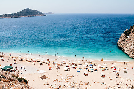 aerial view photography of people walking near sea during daytime thumbnail