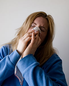 woman covering her nose with handkerchief thumbnail