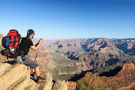 man sitting on mountain rock thumbnail