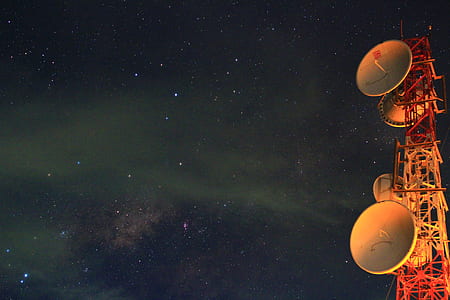 white and orange signal tower during nighttime thumbnail