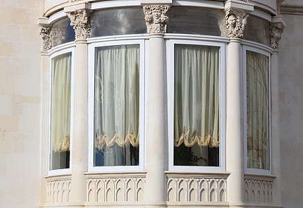 white curtain covered clear glass window in balcony thumbnail