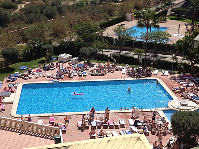 people sunbathing near swimming pool thumbnail
