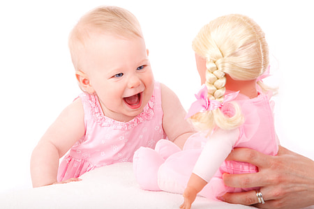 baby wearing pink dress near doll in pink dress thumbnail