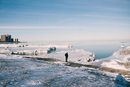 man standing on ground covered with snow during daytime thumbnail
