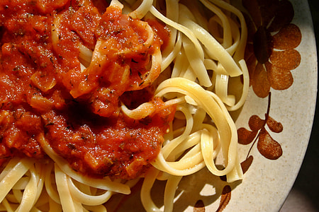 yellow pasta with red sauce on plate thumbnail