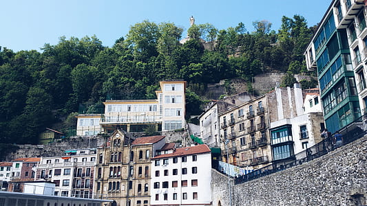 white concrete houses near mountain thumbnail