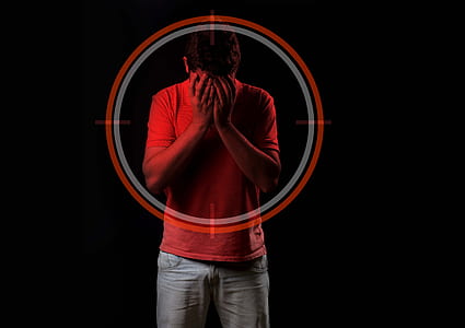 man standing in front of black wall thumbnail