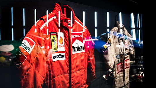 red Marlboro jacket near brown jacket thumbnail